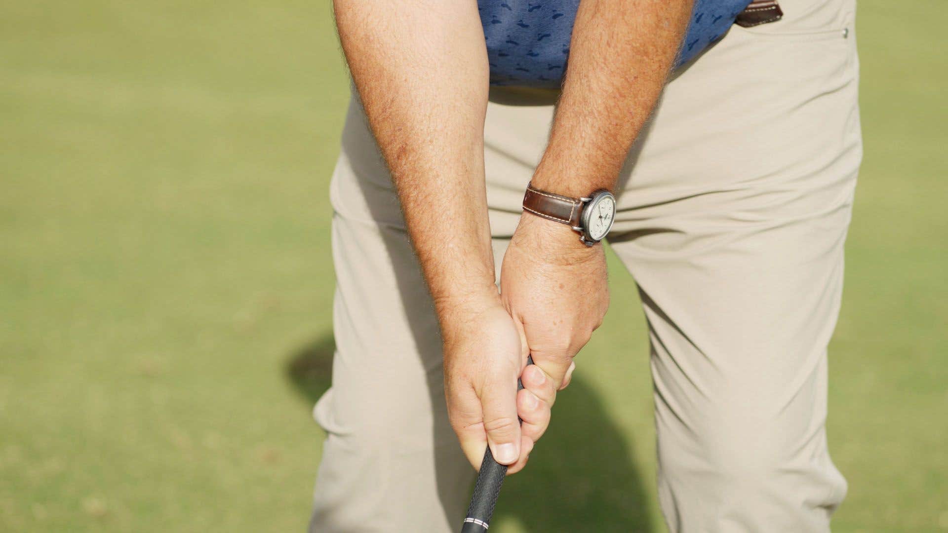 How hard should I grip the club?