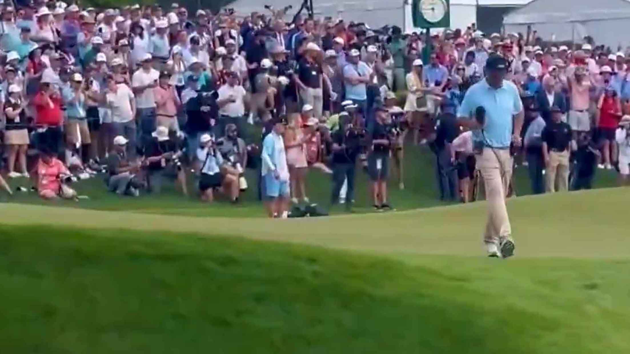 Jim "Bones" Mackay kicks a sex toy off the 18th green at the Tour Championship