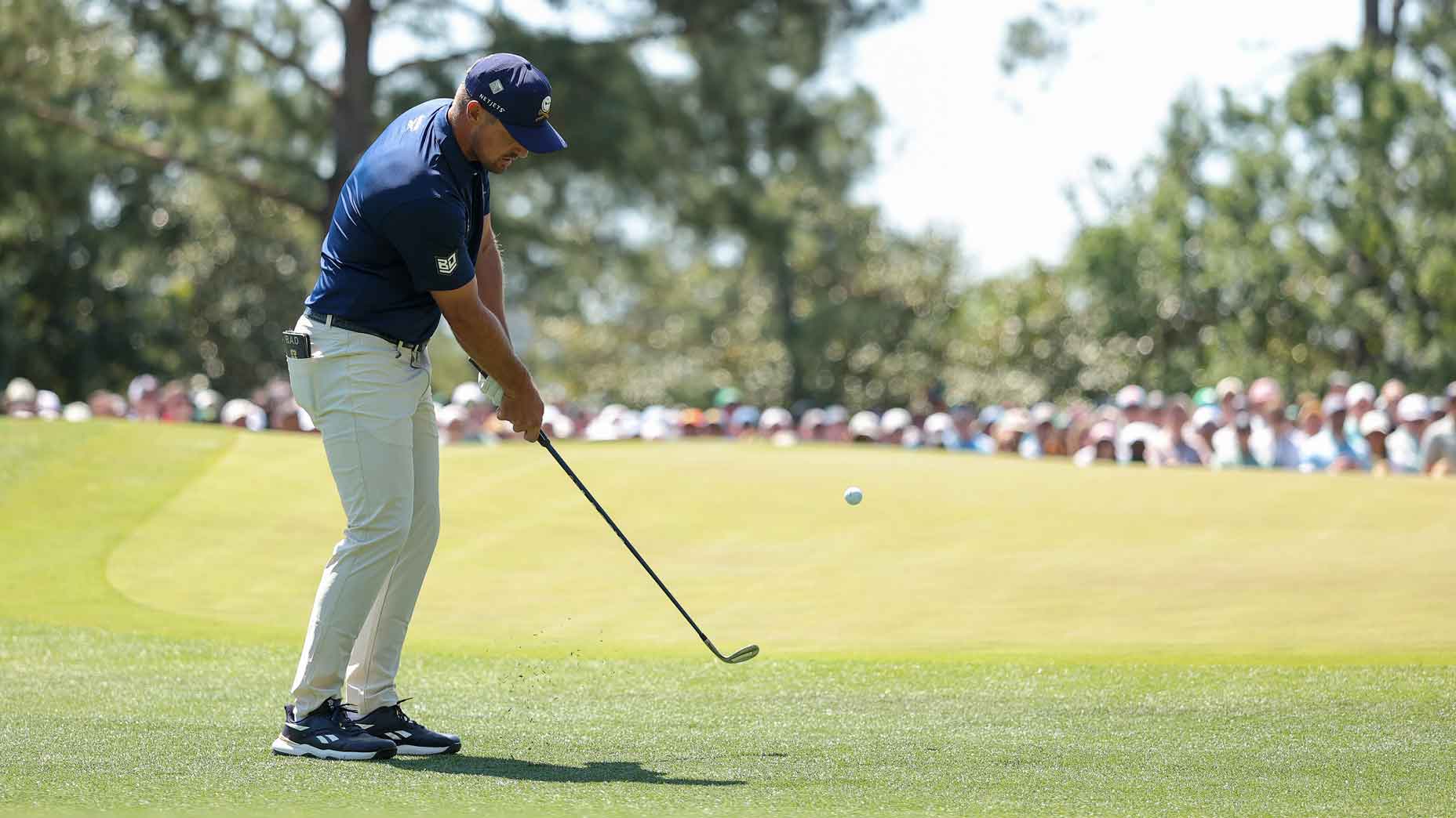 bryson dechambeau hits chip shot during the 2025 masters