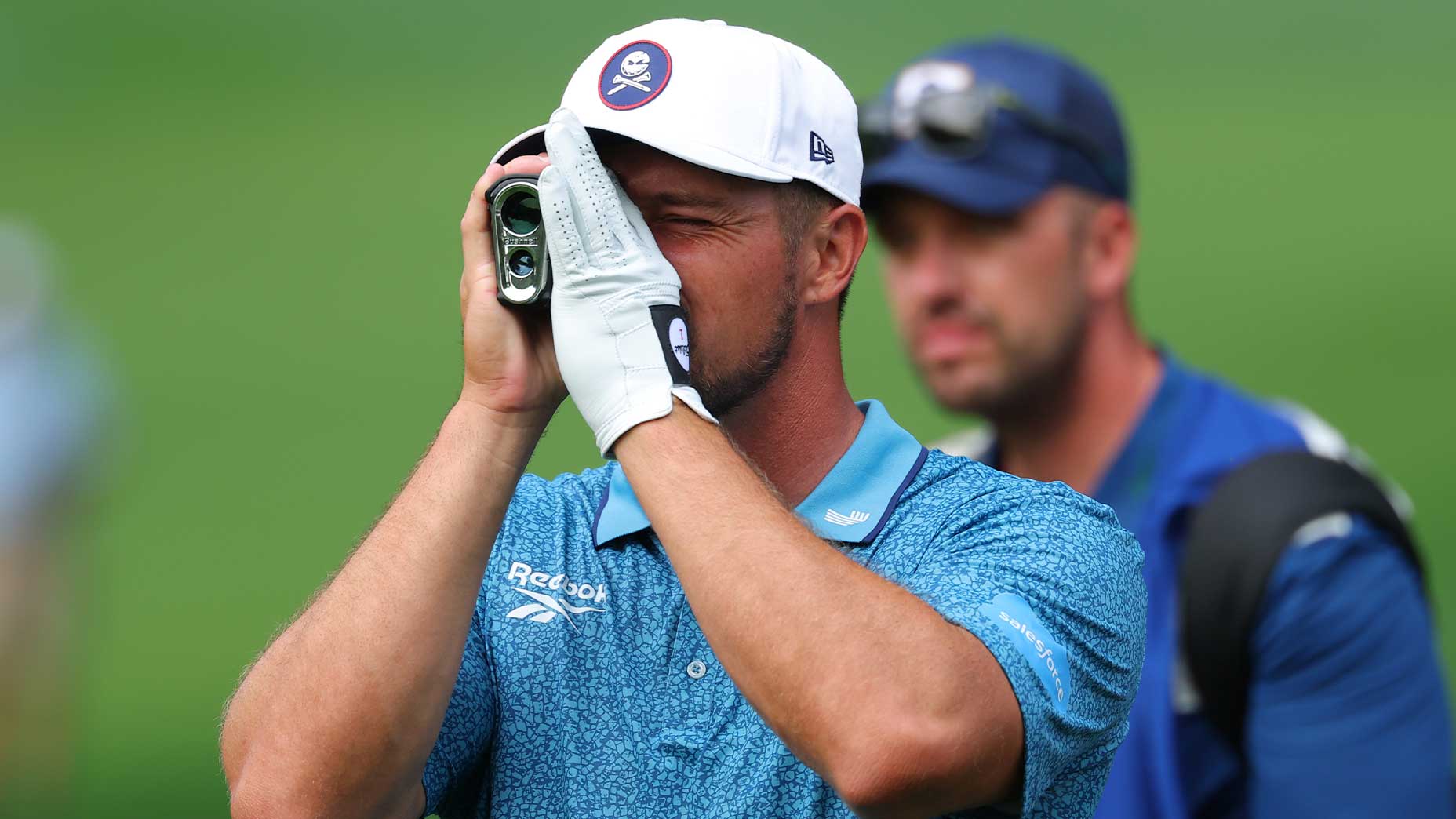 Bryson DeChambeau of the United States uses a rangefinder before hitting an approach shot on the 12th hole during the second round of the PGA Championship at Quail Hollow Country Club on May 16, 2025 in Charlotte, North Carolina.
