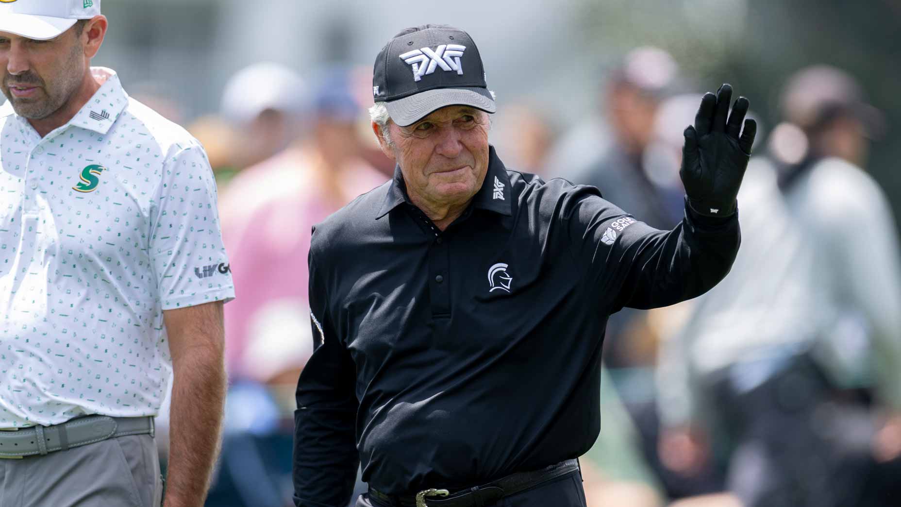 Gary Player walks with Masters champion Charl Schwartzel of during the Par 3 Contest at Augusta National.