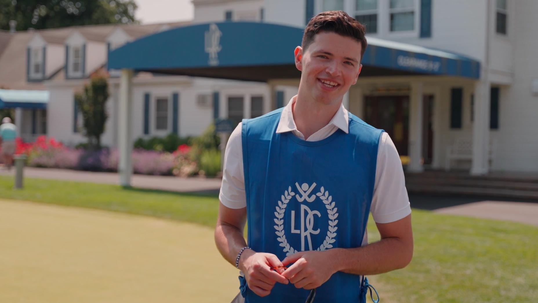 james colgan speaks in front of the rockville links clubhouse on long island in a blue caddie bib