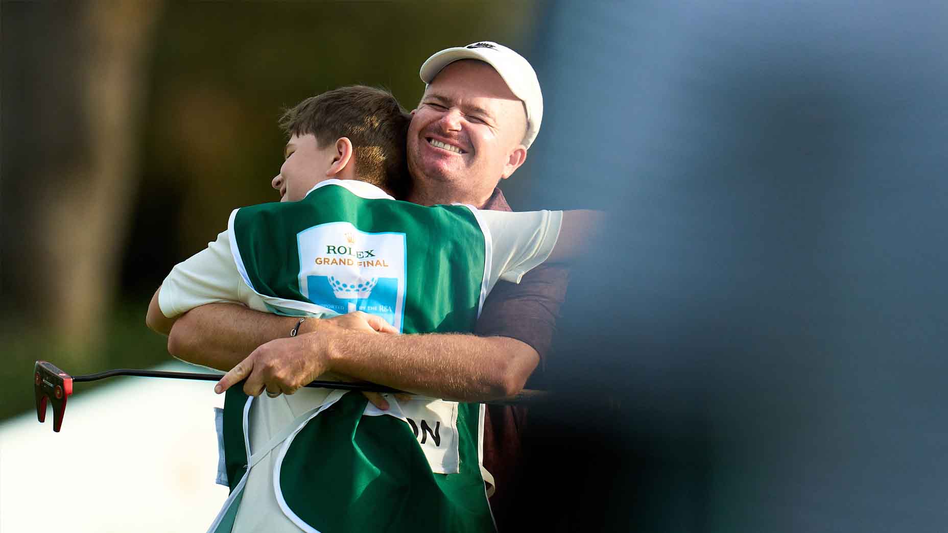 James Morrison embraces his son after winning the Rolex Grand Final