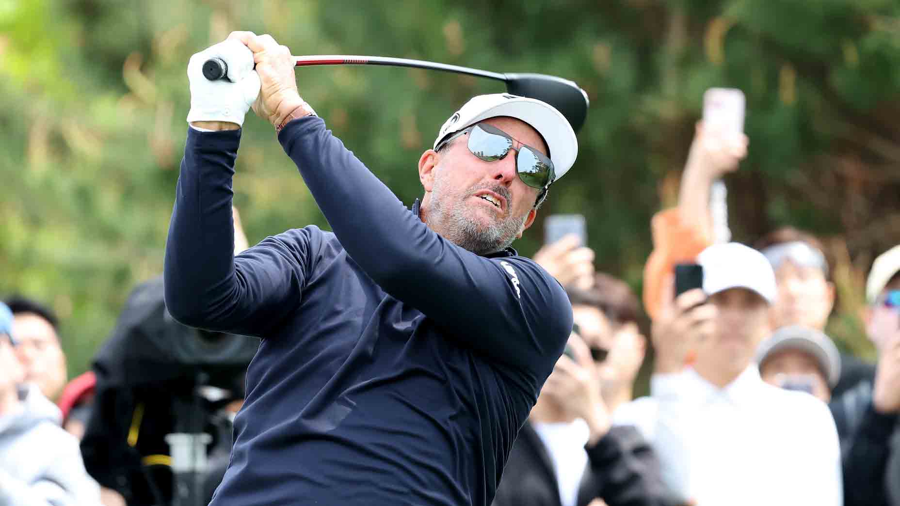 Phil Mickelson hits a drive during a LIV Golf tournament.