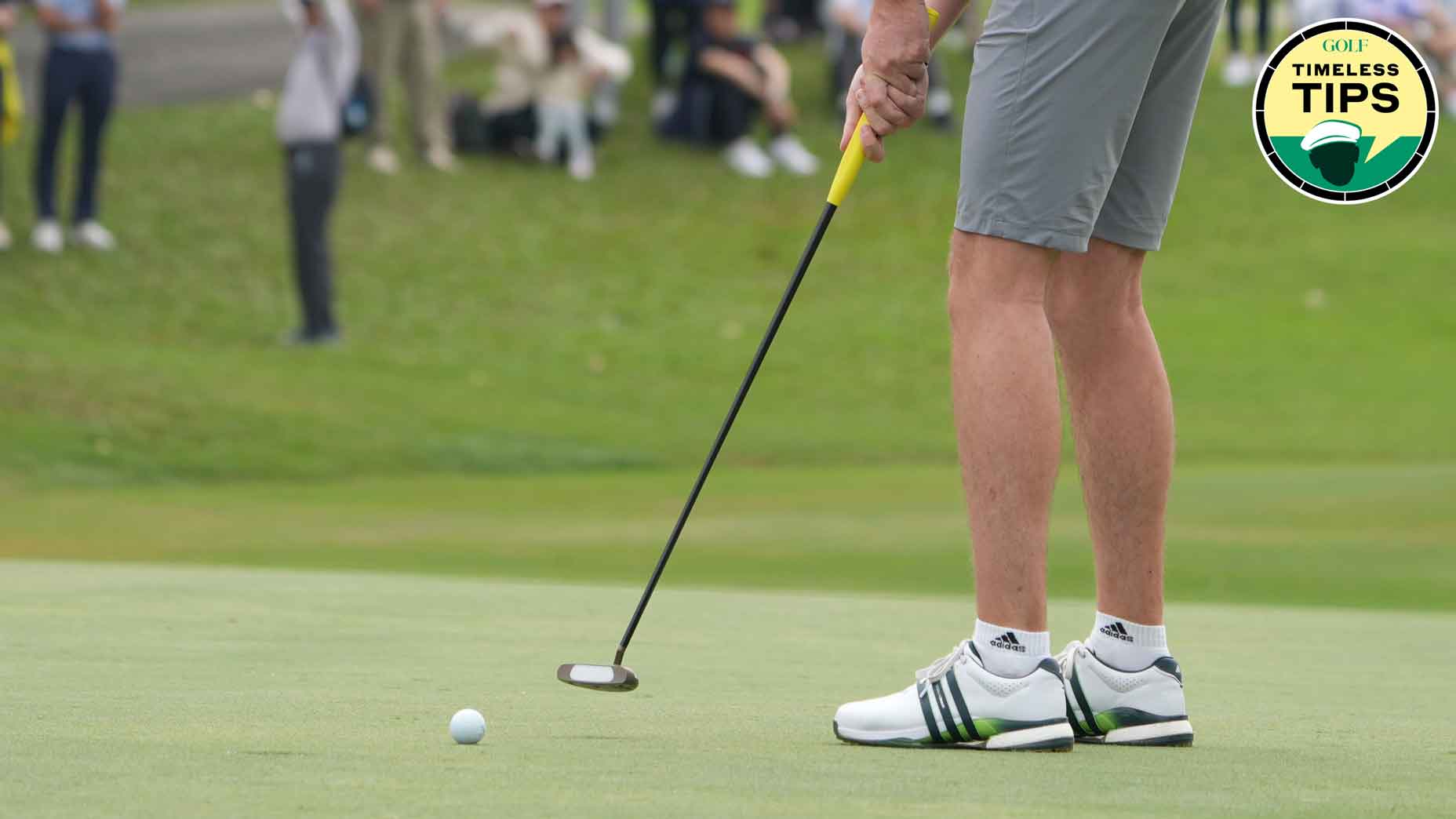 golfer in grey shorts hitts putt