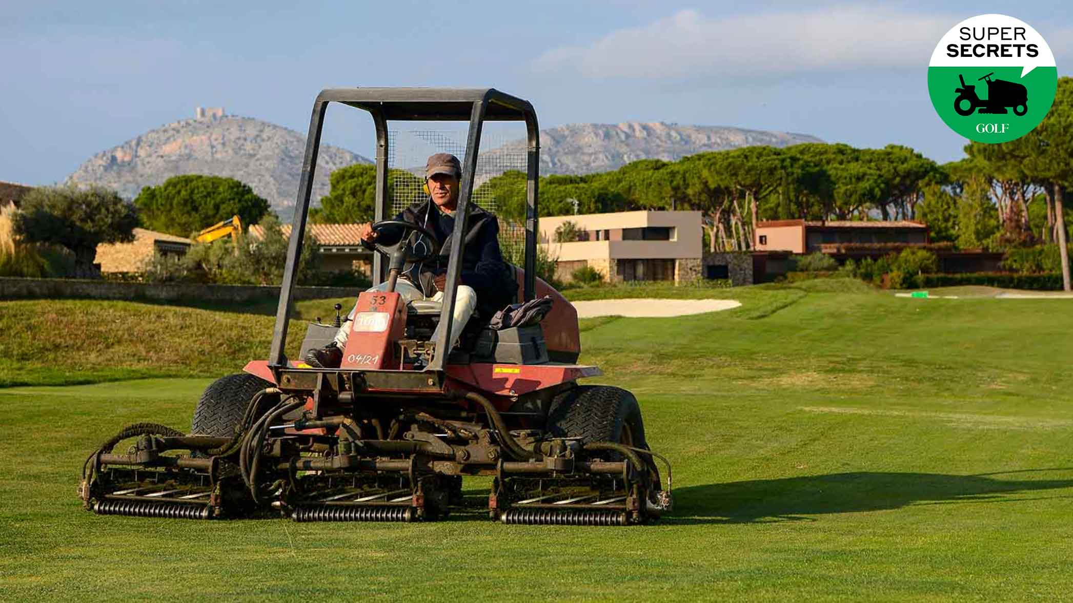 a man mows on a golf course