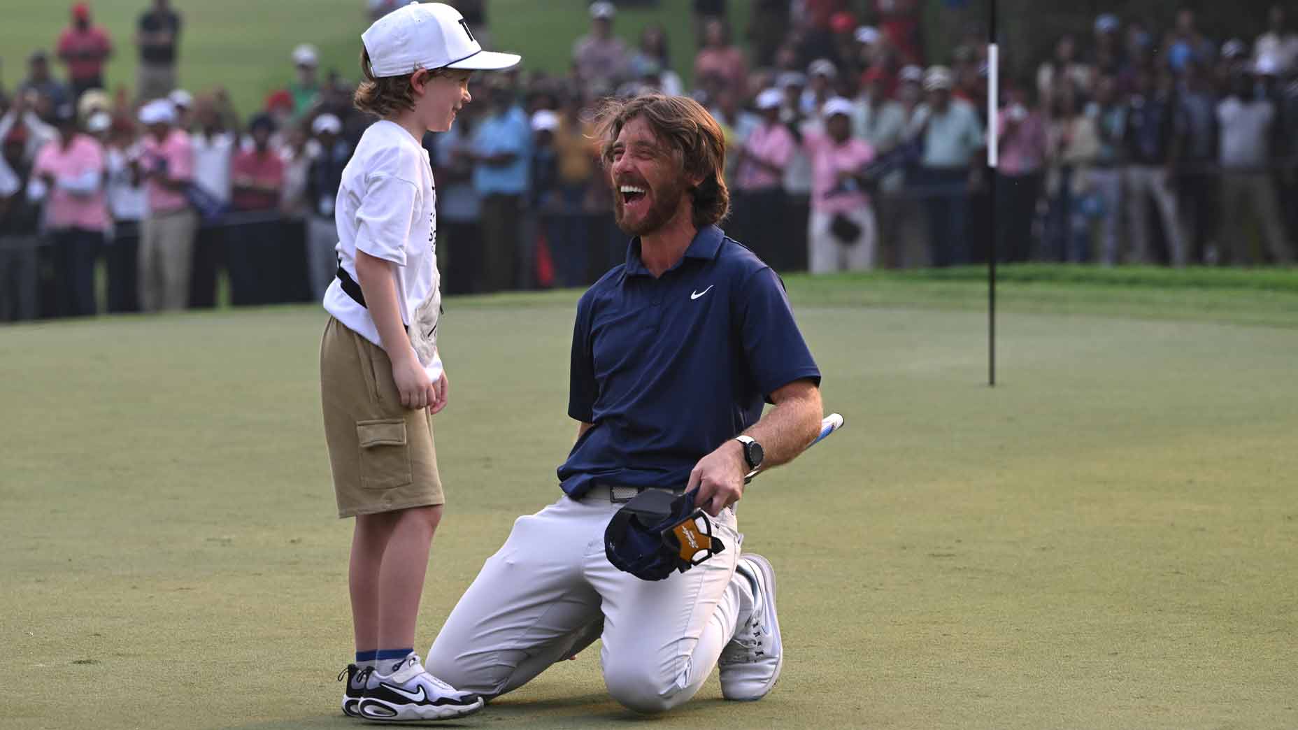Tommy Fleetwood of England (R) celebrates with, his son, Frankie Fleetwood (L) following victory on day four of the DP World India Championship 2025 at Delhi Golf Club on October 19, 2025 in New Delhi, India.